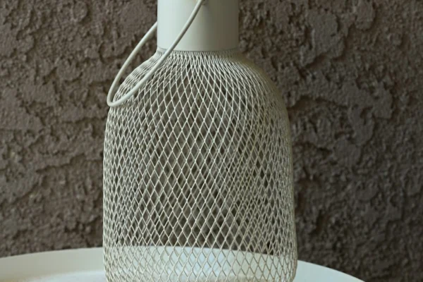 a white vase sitting on top of a white table