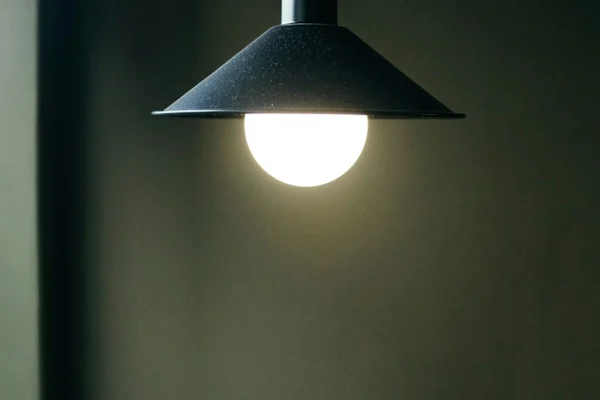 black pendant lamp turned on in room