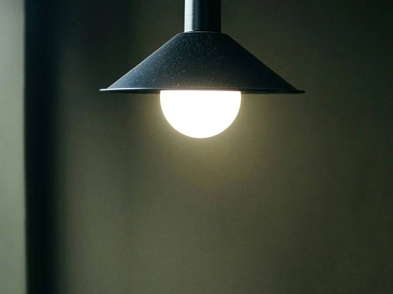 black pendant lamp turned on in room